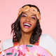 Close-up of woman in doughnut costume wearing a headband resembling a chain of doughnuts